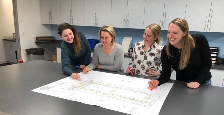 Jess Nicole Jenn Brittney look at a plan scaled