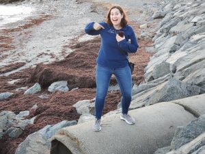 civil engineer Kelsey Kern on a stormwater pipe