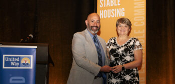 Lisa Receiving Award From Marty Martinez CEO Of United Way Of Ma Bay