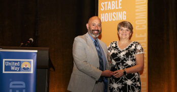 Lisa Receiving Award From Marty Martinez CEO Of United Way Of Ma Bay