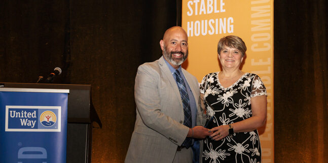 Lisa Receiving Award From Marty Martinez CEO Of United Way Of Ma Bay