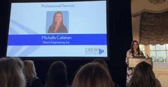 Michelle pictured on stage, giving a speech as she accepts the award.