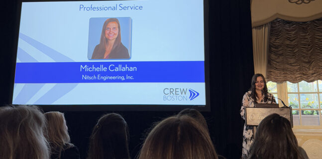 Michelle pictured on stage, giving a speech as she accepts the award.