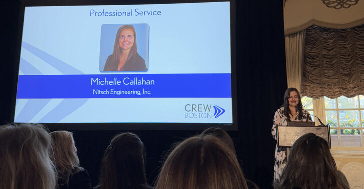 Michelle pictured on stage, giving a speech as she accepts the award.